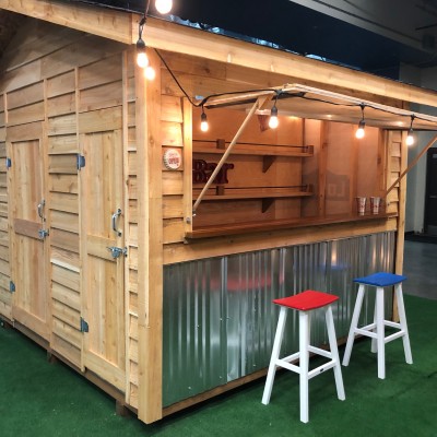 10x10 Cedar Bar Shed divided 60/40. The 40 square feet of Bar includes an 8' bar top and flip up opening, custom shelving, cedar ship lap on the interior and a 24 wood entry door. The 60 square feet of storage has L shaped 16 deep shelves and a 36 wood do